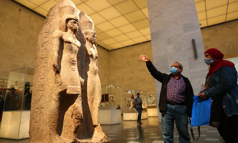 Visitors look at the stone statues on display inside the National Museum of Egyptian Civilization in Cairo, Egypt, April 4, 2021. (Photo: Xinhua)