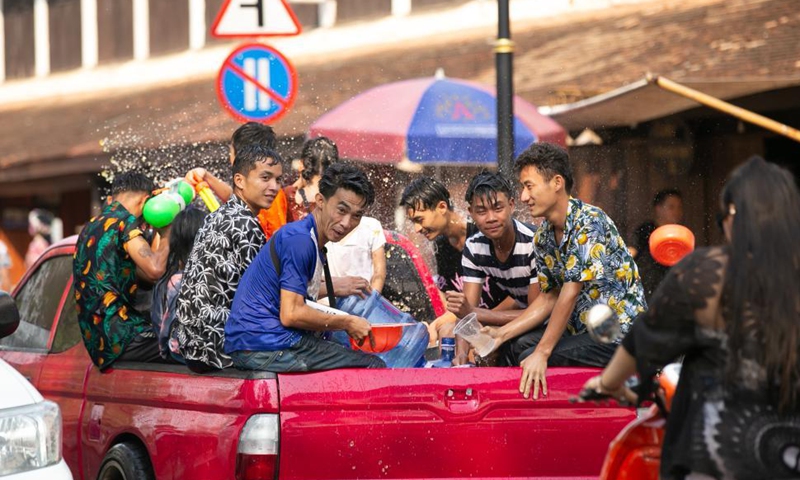 People sprinkle water to a monk during a parade celebrating the Songkran Festival or the Lao New Year in Luang Prabang, Laos, April 15, 2021.Photo: Xinhua