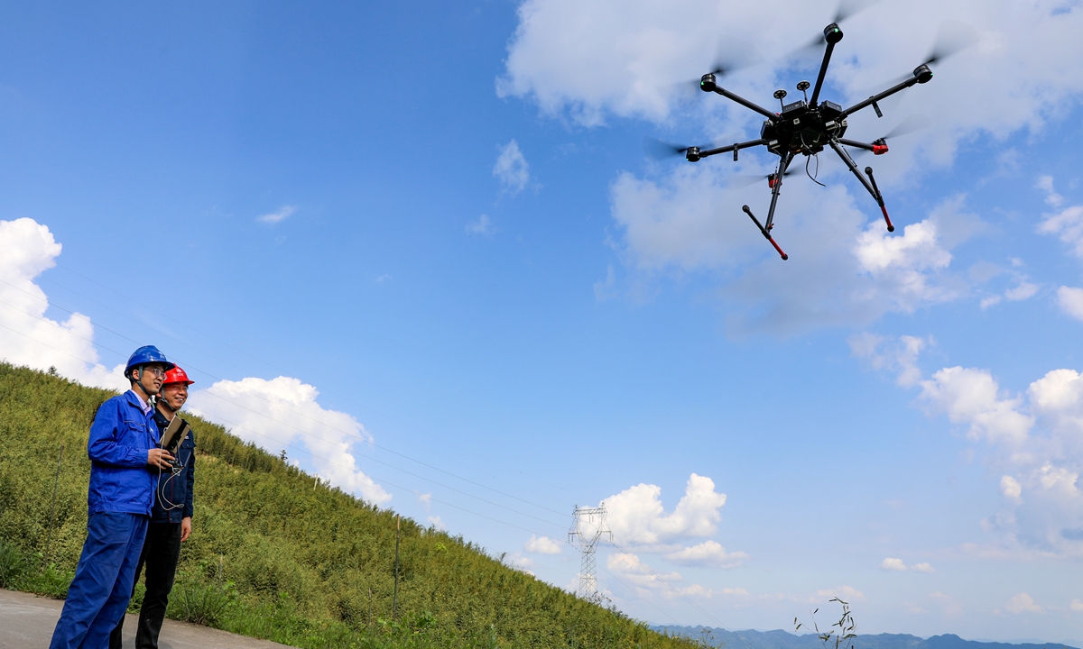 Workers from State Grid Corp of China use drones to carry out routine checks of power transmission lines in Southwest China's Sichuan Province. The checks are being conducted ahead of the May Day holiday to avert the risks of fires as the power lines go through forest areas. Photo: VCG