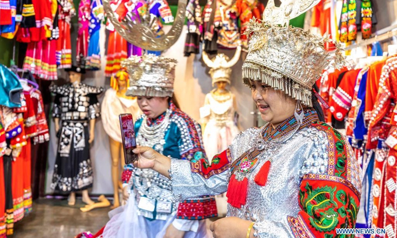 Tourists try on traditional clothes at the Danzhai Wanda Town in Danzhai County, Qiandongnan Miao and Dong Autonomous Prefecture, southwest China's Guizhou Province, April 21, 2021.(Photo: Xinhua)