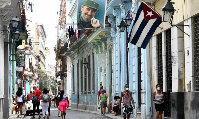 People wearing face masks are seen on a street in Havana, Cuba, April 22, 2021. Cuba registered on Thursday 1,207 new COVID-19 infections in one day, the highest recorded daily figure, bringing the tally to 97,967 cases, the Ministry of Public Health said, adding that there were also another 12 deaths, for a total of 559. Photo:Xinhua