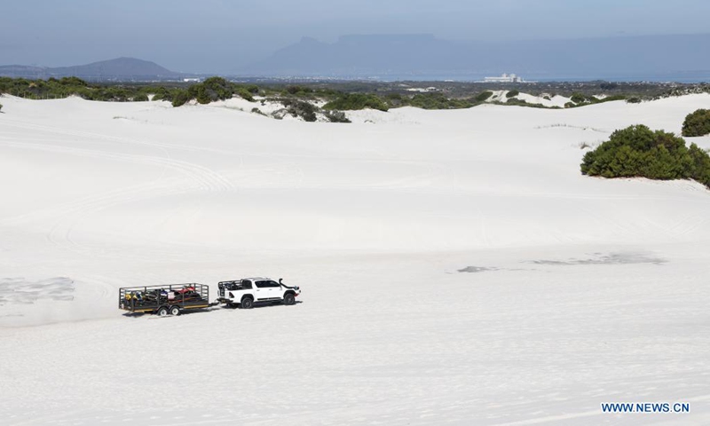 A car drives on dunes at the Witzands Aquifer Nature Reserve, nothern Cape Town, South Africa, on April 23, 2021. The Witzands Aquifer Nature Reserve is famous for the Atlantis dunes which cover 500 hectares of the reserve. It is a flora and fauna-rich landscape. Below the surface, a large underground natural aquifer supplies the surrounding communities with water. The reserve offers activities such as off-road driving, quad biking and sand boarding.Photo:Xinhua