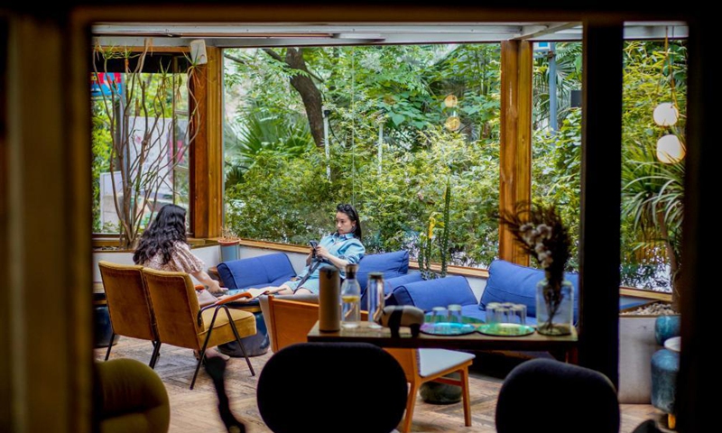 Tourists are seen at a cafe in the Beicang Cultural & Creative Quarter, southwest China's Chongqing, April 22, 2021.Photo:Xinhua