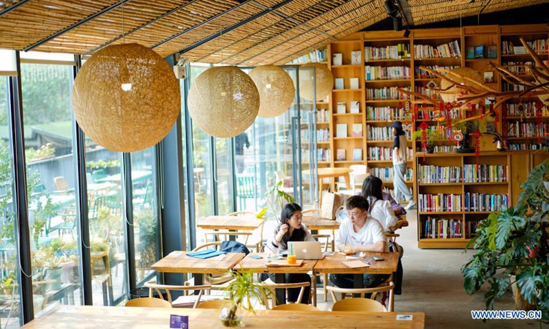 People read at a library in the Beicang Cultural & Creative Quarter, southwest China's Chongqing, April 22, 2021.Photo:Xinhua