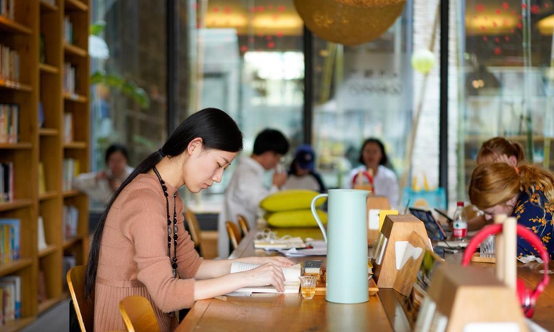 People read at a library in the Beicang Cultural & Creative Quarter, southwest China's Chongqing, April 22, 2021.Photo:Xinhua