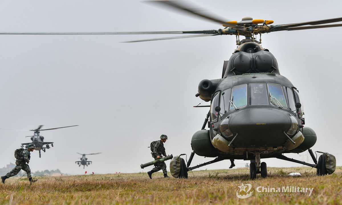 Soldiers assigned to a brigade of the PLA 73rd Group Army run to board a transport helicopter during an air assault landing training exerciseon April 14, 2021. Photo:China Military