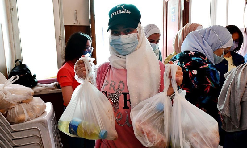 Volunteers prepare charity food parcels during the holy month of Ramadan in Damascus, Syria, on April 20, 2021. As Syria is passing through a tough economic crisis, some charity kitchens started working during the holy month of Ramadan to help people save money by offering free meals and food parcels.Photo:Xinhua