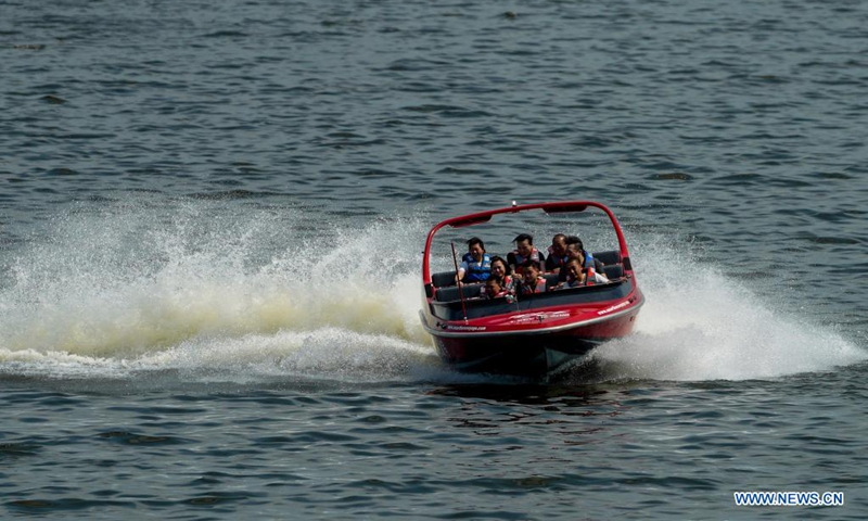 Tourists have fun riding a speedboat at the Changshou Lake scenic area in southwest China's Chongqing, on May 2, 2021. (Xinhua/Liu Chan) 