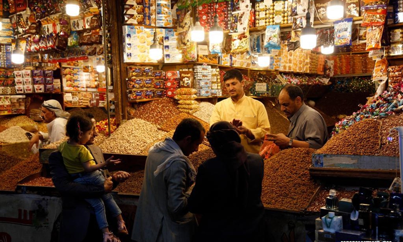 Yemenis buy nuts and sweets ahead of Eid al-Fitr at a market in Sanaa, Yemen, on May 5, 2021. Eid al-Fitr marks the end of the fasting month of Ramadan.(Photo: Xinhua)