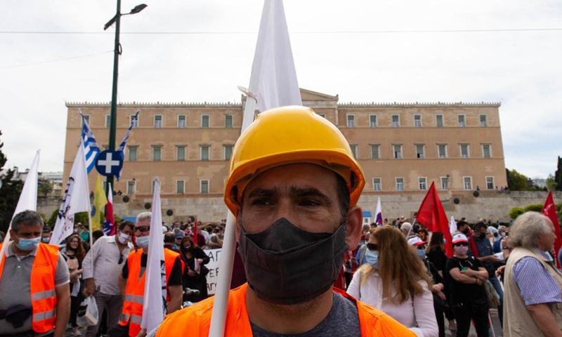 Workers in their uniforms are seen among the demonstrators in front of the Greek Parliament in Athens, Greece, on May 6, 2021. Thousands of protesters hit the streets of Athens and other major cities on Thursday in rallies organized by labor unions to mark a belated May Day in Greece. Photo:Xinhua