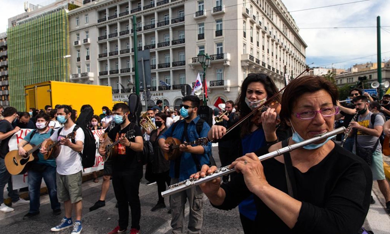 Musicians playing instruments are seen among the demonstrators at Syntagma square in Athens, Greece, on May 6, 2021. Thousands of protesters hit the streets of Athens and other major cities on Thursday in rallies organized by labor unions to mark a belated May Day in Greece. Photo:Xinhua