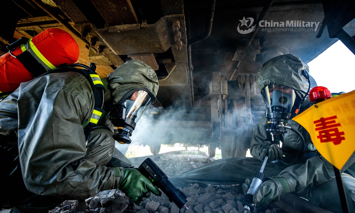 Armed policemen in Mission-Oriented Protective Posture (MOPP) gears use the chemical agent detector to locate the simulated toxic agents for sampling analysis in the railway ballast. A chemical defense element under the Chinese People’s Armed Police (PAP) Force Tianjin Contingent conducted an emergency training exercise on April 28, 2021.Photo: China Military Online