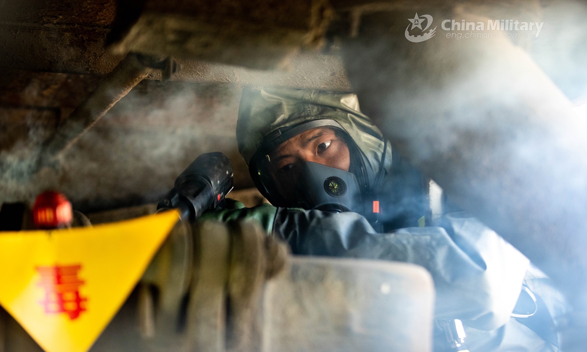 Armed policemen in Mission-Oriented Protective Posture (MOPP) gears use the chemical agent detector to locate the simulated toxic agents for sampling analysis in the railway ballast. A chemical defense element under the Chinese People’s Armed Police (PAP) Force Tianjin Contingent conducted an emergency training exercise on April 28, 2021.Photo: China Military Online