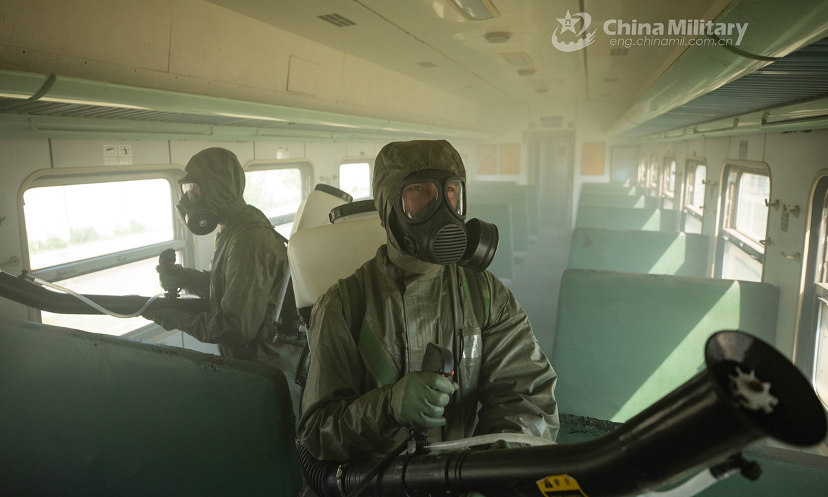 Armed policemen in Mission-Oriented Protective Posture (MOPP) gears follow poisonous gas decontamination procedures in a simulated railway carriage during a chemical defense training exercise. A chemical defense element under the Chinese People’s Armed Police (PAP) Force Tianjin Contingent conducted an emergency training exercise on April 28, 2021.Photo: China Military Online