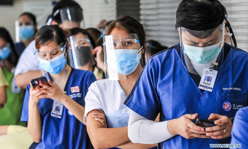 Nurses wearing protective masks line up for an event named nurses community pantry inside a hospital in Manila, the Philippines on May 12, 2021. The nurses community pantry is an event where baskets of food, shoes, bags and other items are given to nurses in celebration of the International Nurses Day, which falls on May 12, to pay tribute to all nurses. (Photo: Xinhua)