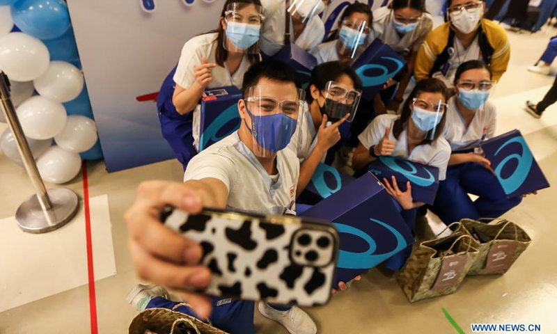 Nurses wearing protective masks take a group photo during an event named nurses community pantry inside a hospital in Manila, the Philippines on May 12, 2021.(Photo: Xinhua)