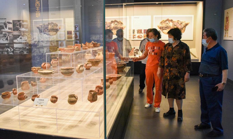 Visitors watch exhibits at the Turpan Museum, Turpan, northwest China's Xinjiang Uygur Autonomous Region, May 13, 2021. More and more tourists choose to visit Turpan, a city noted for its splendid historical culture. The Turpan Museum, home to a collection of more than 20,000 relics, has become an emerging tourist attraction for the city.Photo:Xinhua