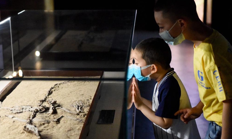 Visitors watch exhibits at the Turpan Museum, Turpan, northwest China's Xinjiang Uygur Autonomous Region, May 13, 2021. More and more tourists choose to visit Turpan, a city noted for its splendid historical culture. The Turpan Museum, home to a collection of more than 20,000 relics, has become an emerging tourist attraction for the city.Photo:Xinhua