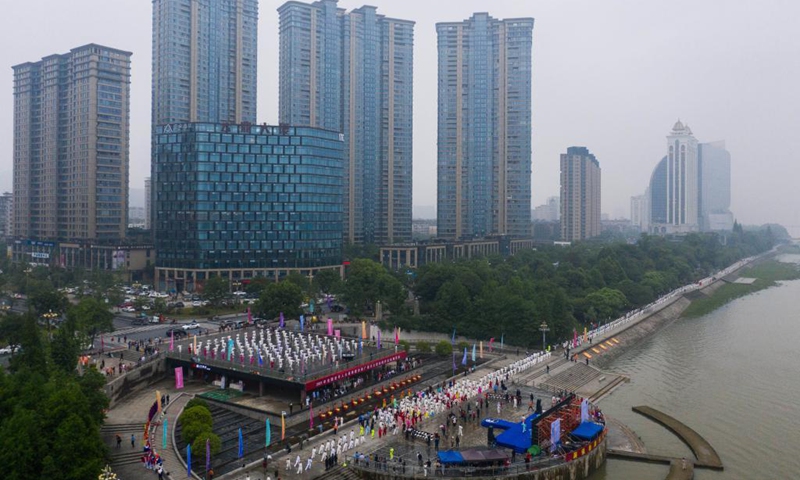 Aerial photo taken on May 19, 2021 shows senior hobbyists of Taijiquan, a traditional Chinese martial art, demonstrating Taijiquan moves by Fuchunjiang River in Tonglu County, east China's Zhejiang Province. A nation-wide campaign to promote and demonstrate Taijiquan as a fitness exercise among senior citizens was launched here on Wednesday. More than 2,000 Taijiquan hobbyists from all over the country flocked in to participate in the demonstrations and performances.(Photo: Xinhua)