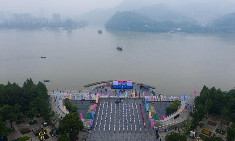 Aerial photo taken on May 19, 2021 shows senior hobbyists of Taijiquan, a traditional Chinese martial art, demonstrating Taijiquan moves by Fuchunjiang River in Tonglu County, east China's Zhejiang Province. A nation-wide campaign to promote and demonstrate Taijiquan as a fitness exercise among senior citizens was launched here on Wednesday. More than 2,000 Taijiquan hobbyists from all over the country flocked in to participate in the demonstrations and performances.(Photo: Xinhua)