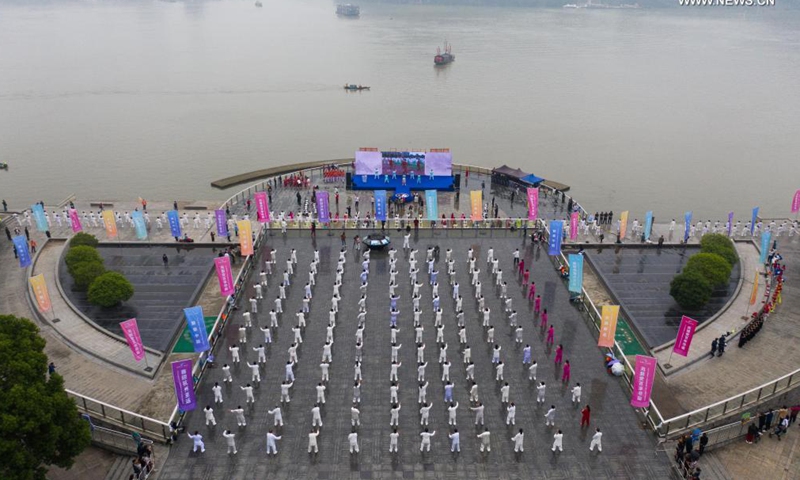 Aerial photo taken on May 19, 2021 shows senior hobbyists of Taijiquan, a traditional Chinese martial art, demonstrating Taijiquan moves by Fuchunjiang River in Tonglu County, east China's Zhejiang Province. A nation-wide campaign to promote and demonstrate Taijiquan as a fitness exercise among senior citizens was launched here on Wednesday. More than 2,000 Taijiquan hobbyists from all over the country flocked in to participate in the demonstrations and performances.(Photo: Xinhua)