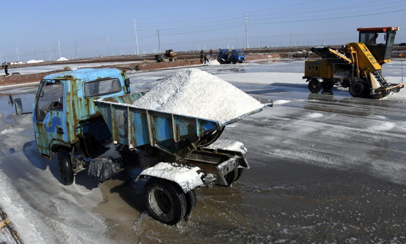 Workers harvest salt in a salt field at Binhai Township, Zhanhua District, Binzhou City of east China's Shandong Province, on May 18, 2021. Workers have started harvesting spring salt from the 600,000-mu (40,000 hectares) of salt fields at Binhai Township. The total output is expected to hit 500,000 tons when the harvest work concludes by the end of June.Photo:Xinhua