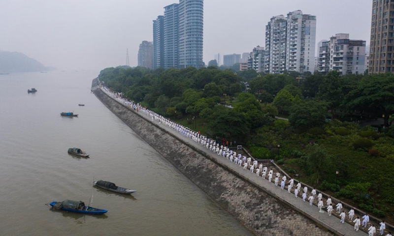 Aerial photo taken on May 19, 2021 shows senior hobbyists of Taijiquan, a traditional Chinese martial art, demonstrating Taijiquan moves by Fuchunjiang River in Tonglu County, east China's Zhejiang Province. A nation-wide campaign to promote and demonstrate Taijiquan as a fitness exercise among senior citizens was launched here on Wednesday. More than 2,000 Taijiquan hobbyists from all over the country flocked in to participate in the demonstrations and performances.(Photo: Xinhua)