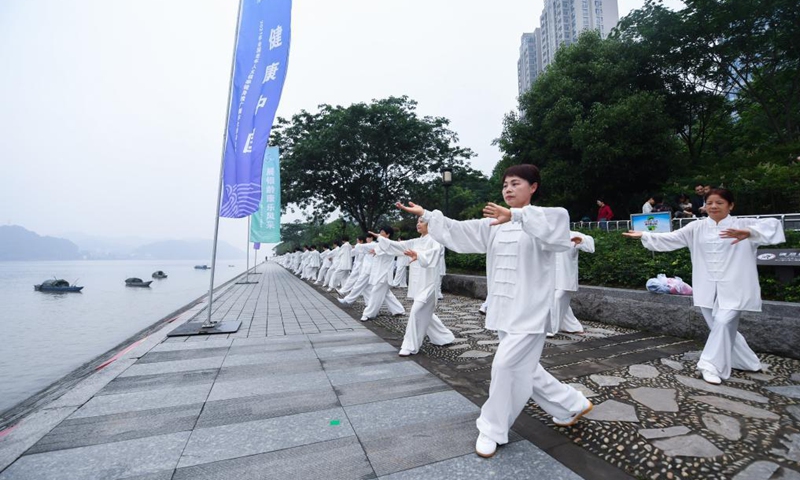 Senior hobbyists of Taijiquan, a traditional Chinese martial art, demonstrate Taijiquan moves by Fuchunjiang River in Tonglu County, east China's Zhejiang Province, on May 19, 2021. A nation-wide campaign to promote and demonstrate Taijiquan as a fitness exercise among senior citizens was launched here on Wednesday. More than 2,000 Taijiquan hobbyists from all over the country flocked in to participate in the demonstrations and performances.(Photo: Xinhua)