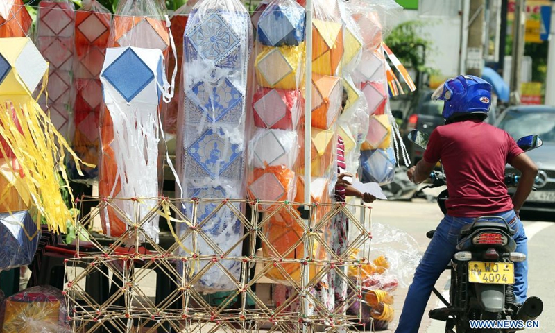 A man looks at lanterns ahead of the Vesak festival in Colombo, Sri Lanka, on May 19, 2021. The Vesak Festival is one of the holiest festivals celebrated in Sri Lanka as it marks the birth, enlightenment and demise of Lord Buddha.(Photo: Xinhua)