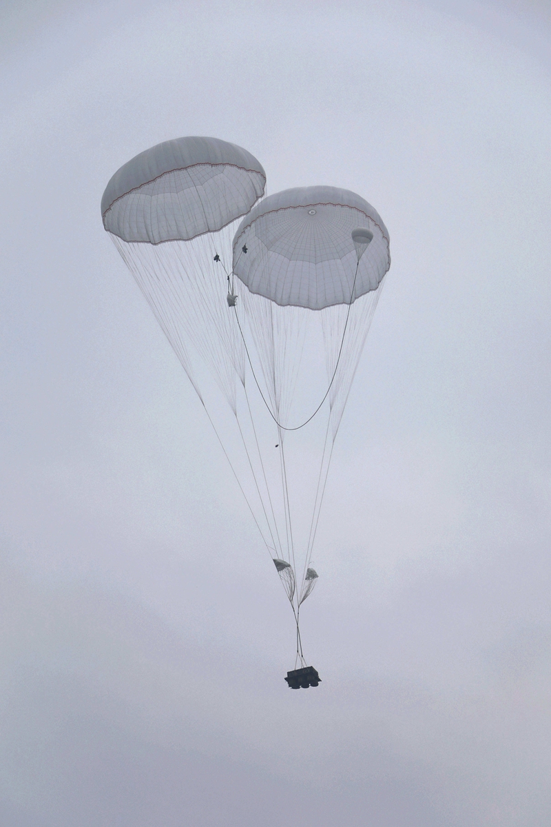 Heavy equipment is dropped from a transport aircraft attached to an airborne brigade under the PLA Air Force in the heavy equipment airdrop training on April 26, 2021. Photo: China Military Online