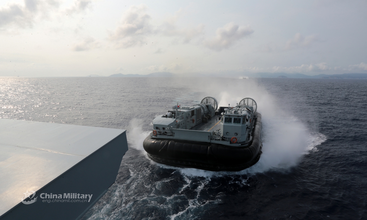 A Landing Craft Air Cushion (LCAC) attached to a naval landing ship flotilla under the PLA Southern Theater Command approaches the well deck of the amphibious dock landing ship during a combat training exercise in late April, 2021. (eng.chinamil.com.cn/Photo by Liu Jinyu)