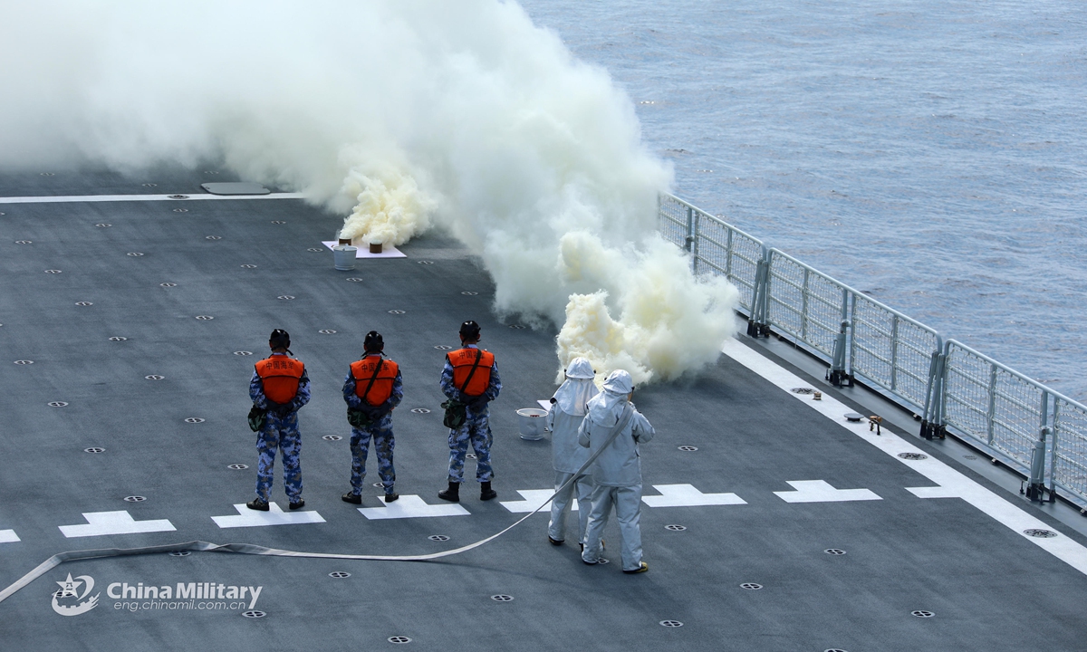 Soldiers assigned toa naval landing ship flotilla under the PLA Southern Theater Command lay a smokescreen during a combat training exercise in late April, 2021. (eng.chinamil.com.cn/Photo by Liu Jinyu)