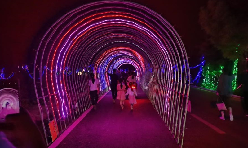 The undated photo shows the beautiful night views featuring dazzling light shows at a modern agricultural industrial park in Matouling, central China's Henan Province. Developed from a barren land to a wonderland, the park has become a large modern agricultural sightseeing demonstration park which integrates fruit tree planting, products processing, sightseeing, and natural-based education. It has become a must-see tourist attraction in the province.(Photo: China News Service/Wang Dengfeng)
