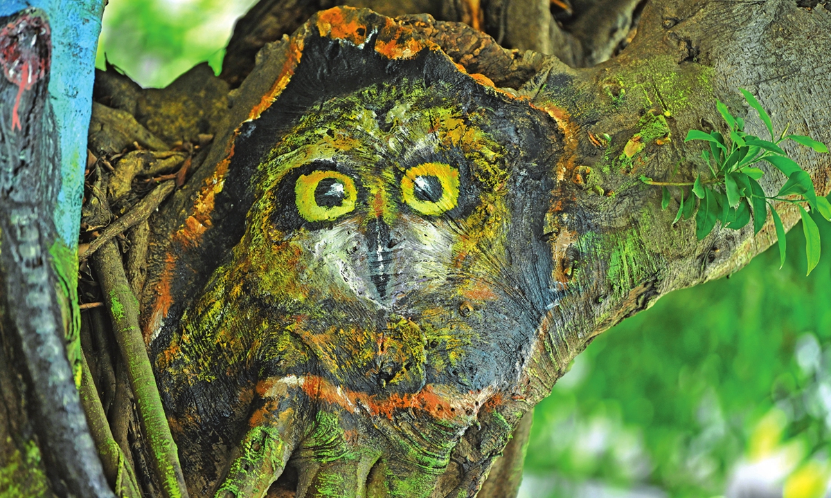 A hand-painted cartoon owl on a tree on a street in Southwest China's Chongqing Municipality Photo: IC