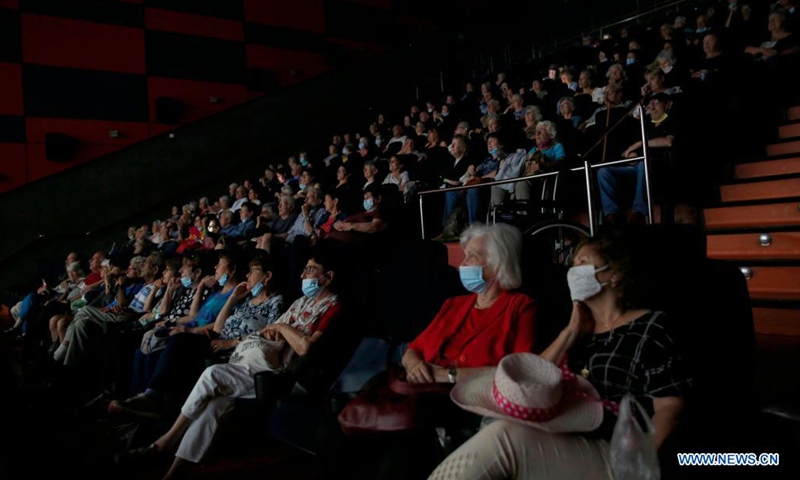 People are seen in a reopened cinema in central Israeli city of Rishon Lezion on May 26, 2021. After months of closure amid COVID-19 pandemic, Israel's movie theaters start to reopen this week. (Photo by Gil Cohen Magen/Xinhua)