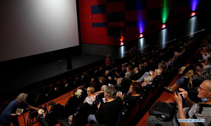 People are seen in a reopened cinema in central Israeli city of Rishon Lezion on May 26, 2021. After months of closure amid COVID-19 pandemic, Israel's movie theaters start to reopen this week. (Photo by Gil Cohen Magen/Xinhua)