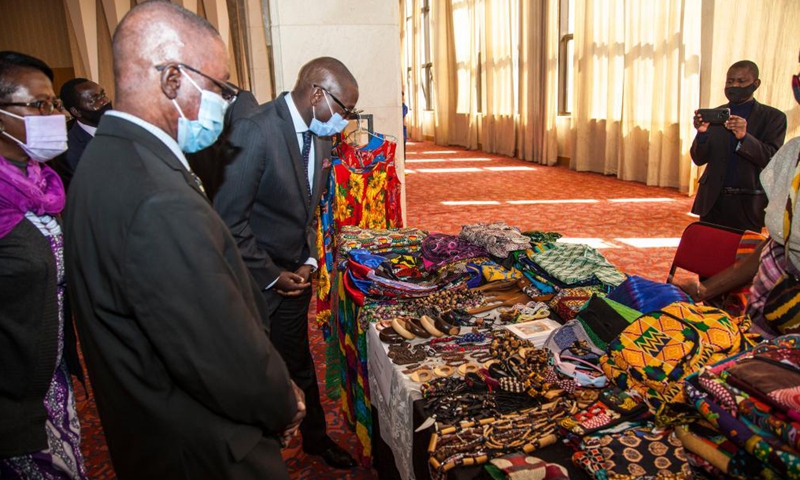 Zambian government officials visit an exhibition at the launch of the Africa Day theme rollout in Lusaka, Zambia, May 26, 2021. Zambia on Wednesday launched the rollout exercise of promoting the 2021 Africa Day commemoration. The theme for this year's commemoration is Arts, Culture and Heritage: Levers for Building the Africa We Want. (Photo by Martin Mbangweta/Xinhua) 

