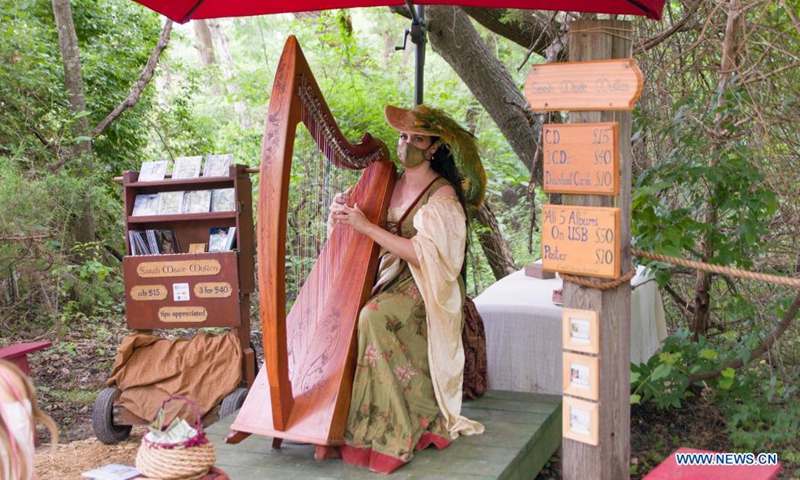 A lady in traditional costume plays a harp at the Scarborough Renaissance Festival on the outskirts of Dallas, Texas, the United States on May 30, 2021. (Photo by Dan Tian/Xinhua)