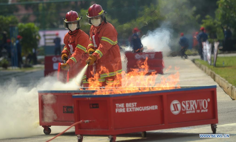 Firefighters compete during the Fire Safety Challenge 2021 competition at Jakarta's firefighter headquarters in Jakarta, Indonesia, June 2, 2021. (Xinhua/Zulkarnain)