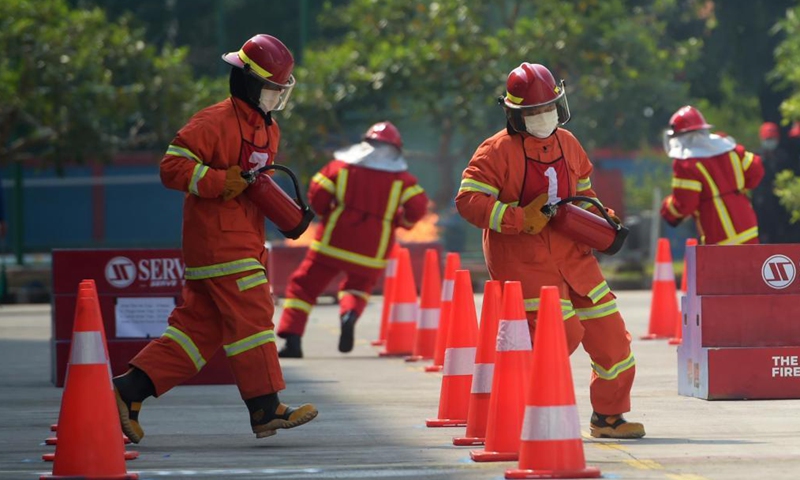 Firefighters compete during the Fire Safety Challenge 2021 competition at Jakarta's firefighter headquarters in Jakarta, Indonesia, June 2, 2021. (Xinhua/Zulkarnain)