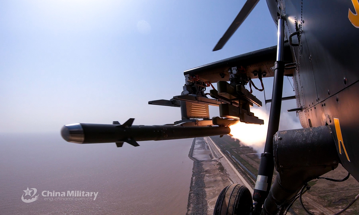 An attack helicopter attached to an army aviation brigade of the PLA 71st Group Army fires air-to-air missile at mock target during a recent round-the-clock live-fire training exercise above China’s Yellow Sea. Pilots' capability has been comprehensively tested and improved during the exercise featured with low altitude operations, in-depth attacks, mixed manned and unmanned operations, and all elements coordination. (eng.chinamil.com.cn/Photo by Xiang Xu)