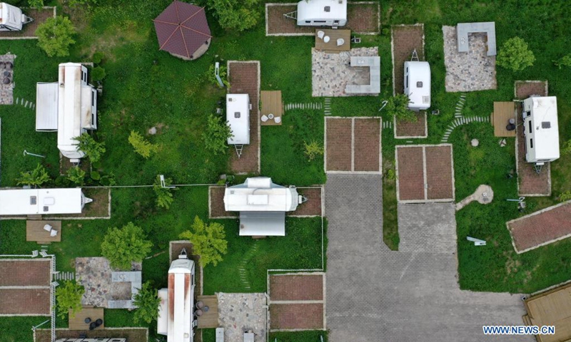 Aerial photo taken on May 20, 2021 shows an RV camp in Huaqiao Village of Kangxian County, Longnan City, northwest China's Gansu Province. (Xinhua/Chen Bin)