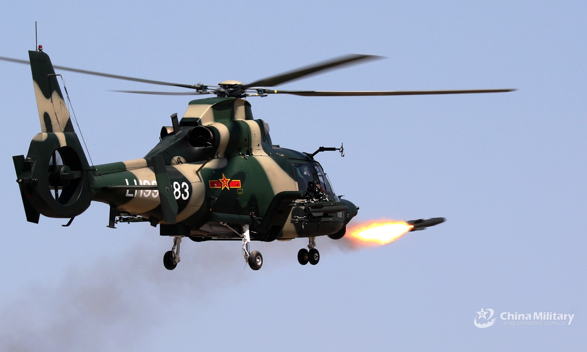 An attack helicopter attached to an army aviation brigade of the PLA 71st Group Army fires air-to-air missile at mock target during a recent round-the-clock live-fire training exercise above China’s Yellow Sea. Pilots' capability has been comprehensively tested and improved during the exercise featured with low altitude operations, in-depth attacks, mixed manned and unmanned operations, and all elements coordination. (eng.chinamil.com.cn/Photo by Xiang Xu)