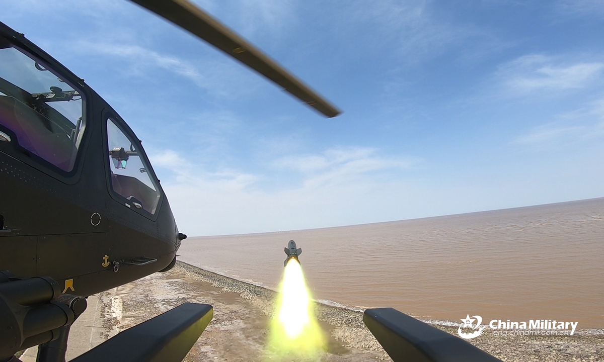 An attack helicopter attached to an army aviation brigade of the PLA 71st Group Army fires air-to-ground missile at mock target during a recent round-the-clock live-fire training exercise above China’s Yellow Sea. Pilots' capability has been comprehensively tested and improved during the exercise featured with low altitude operations, in-depth attacks, mixed manned and unmanned operations, and all elements coordination. (eng.chinamil.com.cn/Photo by Xiang Xu) 