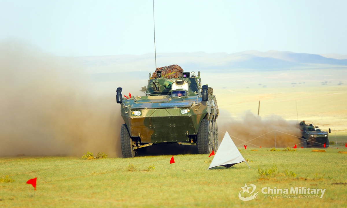 The armored vehicles attached to a combined arms brigade under the PLA 78th Group Army speed toward the designated mission area during the tactical training in early June, 2021. Photo:China Military