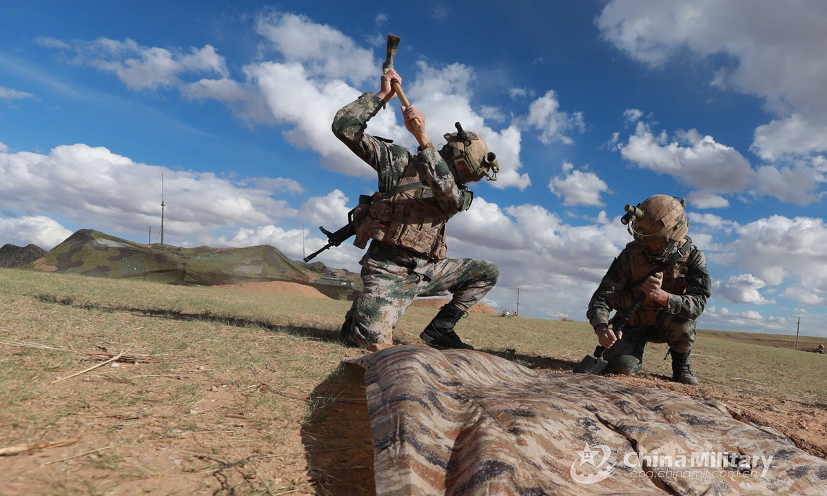 Two soldiers assigned to a combined arms brigade under the PLA 78th Group Army dig field works before the tactical training in early June, 2021.Photo:China Military