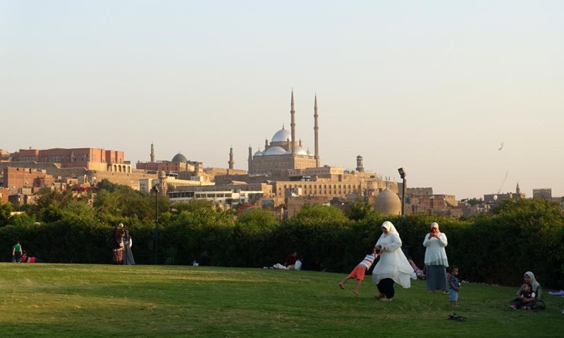 People spend time at Al-Azhar Park with the Saladin Citadel in the background in Cairo, Egypt, on June 5, 2021. Parks in Cairo, which were reopened since mid-May to the public with anti-COVID-19 measures strictly implemented, attract more and more people as the country's coronavirus pandemic recedes with per-day cases dropping to less than 1,000 for consecutive days.(Photo: Xinhua)