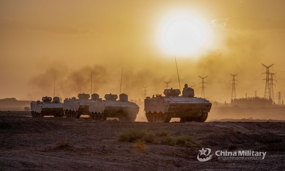 The armored vehicles attached to a combined arms brigade under the 77th Group Army rumble in formation through the wilds during the maneuver training on May 26, 2021. (eng.chinamil.com.cn/Photo by Zhang Danfeng)