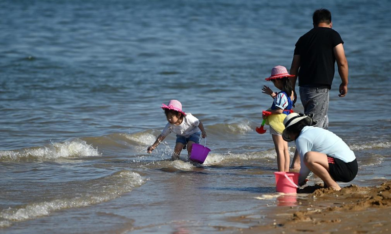 Tourists have fun at an artificial beach resort at Dongjiang Port in the Binhai New Area of north China's Tianjin, June 5, 2021. Tianjin in north China boasts rich biodiversity along a 153-km coastline made up of muddy tidal flats. Photo: Xinhua 