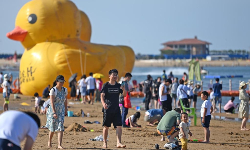 Tourists have fun at an artificial beach resort at Dongjiang Port in the Binhai New Area of north China's Tianjin, June 5, 2021. Tianjin in north China boasts rich biodiversity along a 153-km coastline made up of muddy tidal flats. Photo: Xinhua 